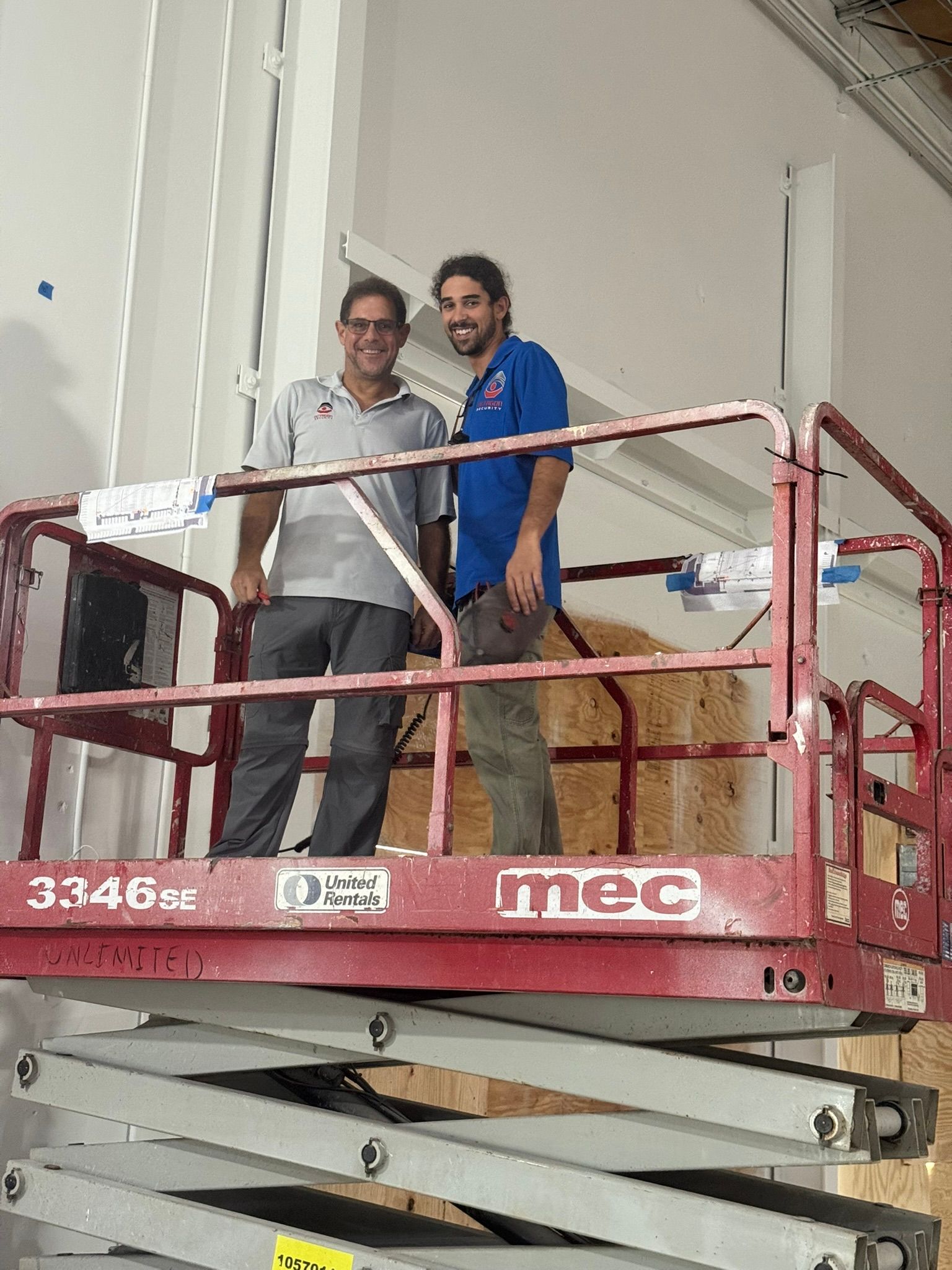 Gray wall with a mounted digital screen showing icons; next to it is a light switch.