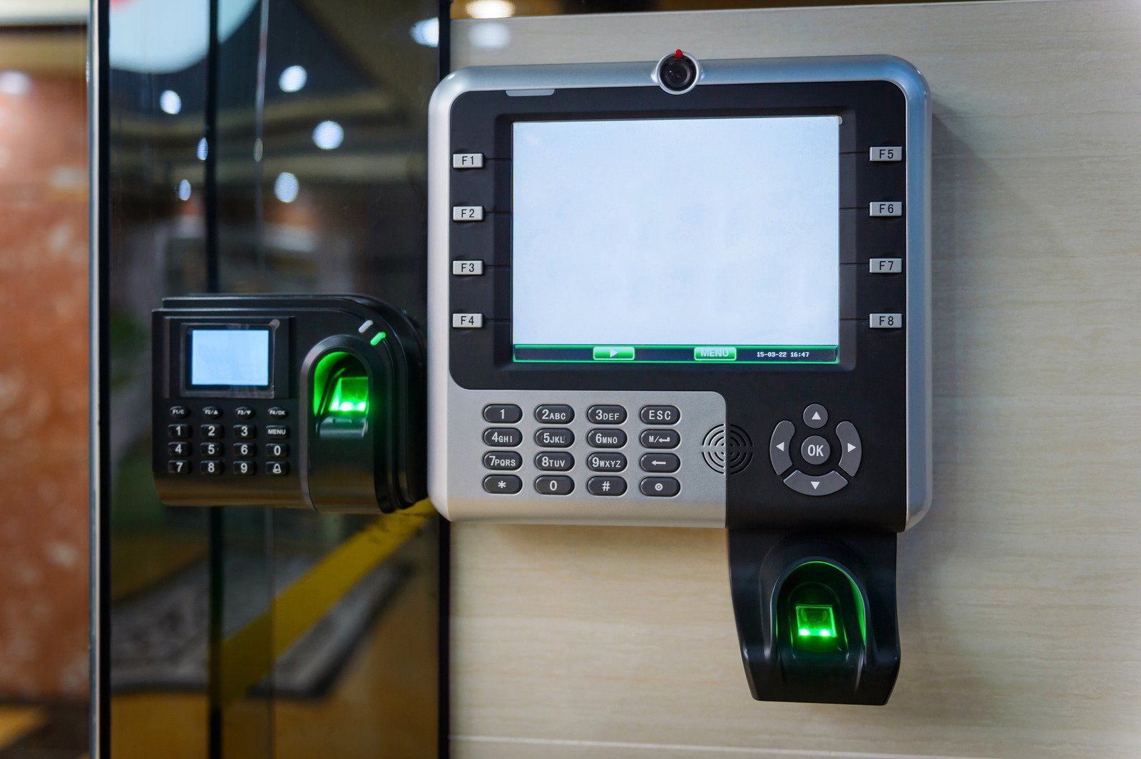 Biometric access control system with fingerprint scanners and keypad mounted on a wall.