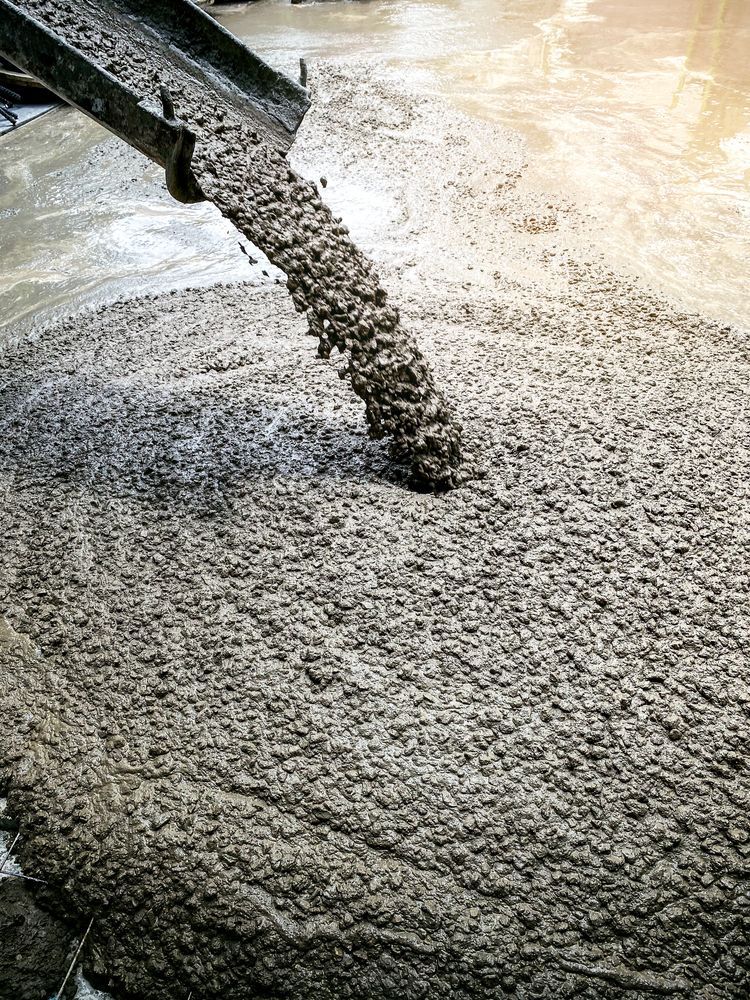 Concrete is being poured into a concrete floor.