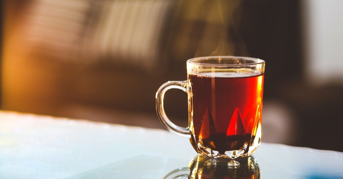 A cup of tea is sitting on a table.