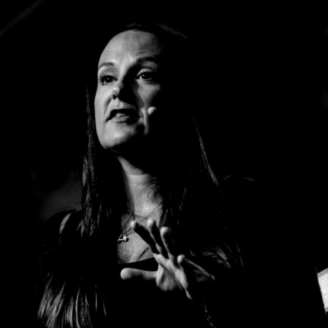 A man is holding a cat in his arms in a black and white photo