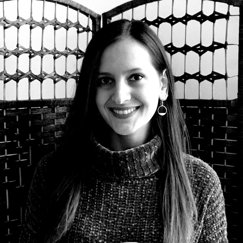 A man is holding a cat in his arms in a black and white photo