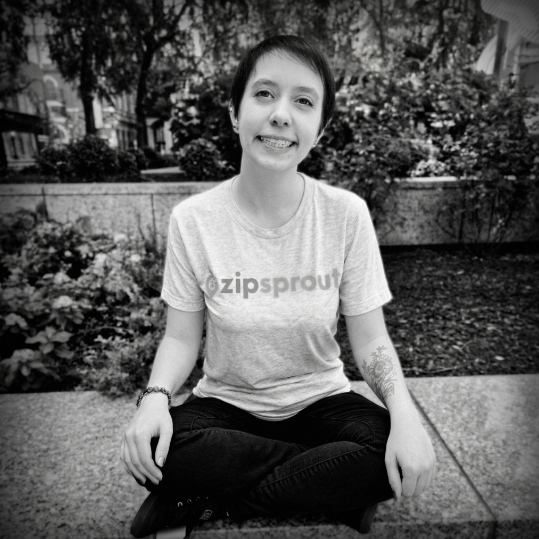 A man is holding a cat in his arms in a black and white photo