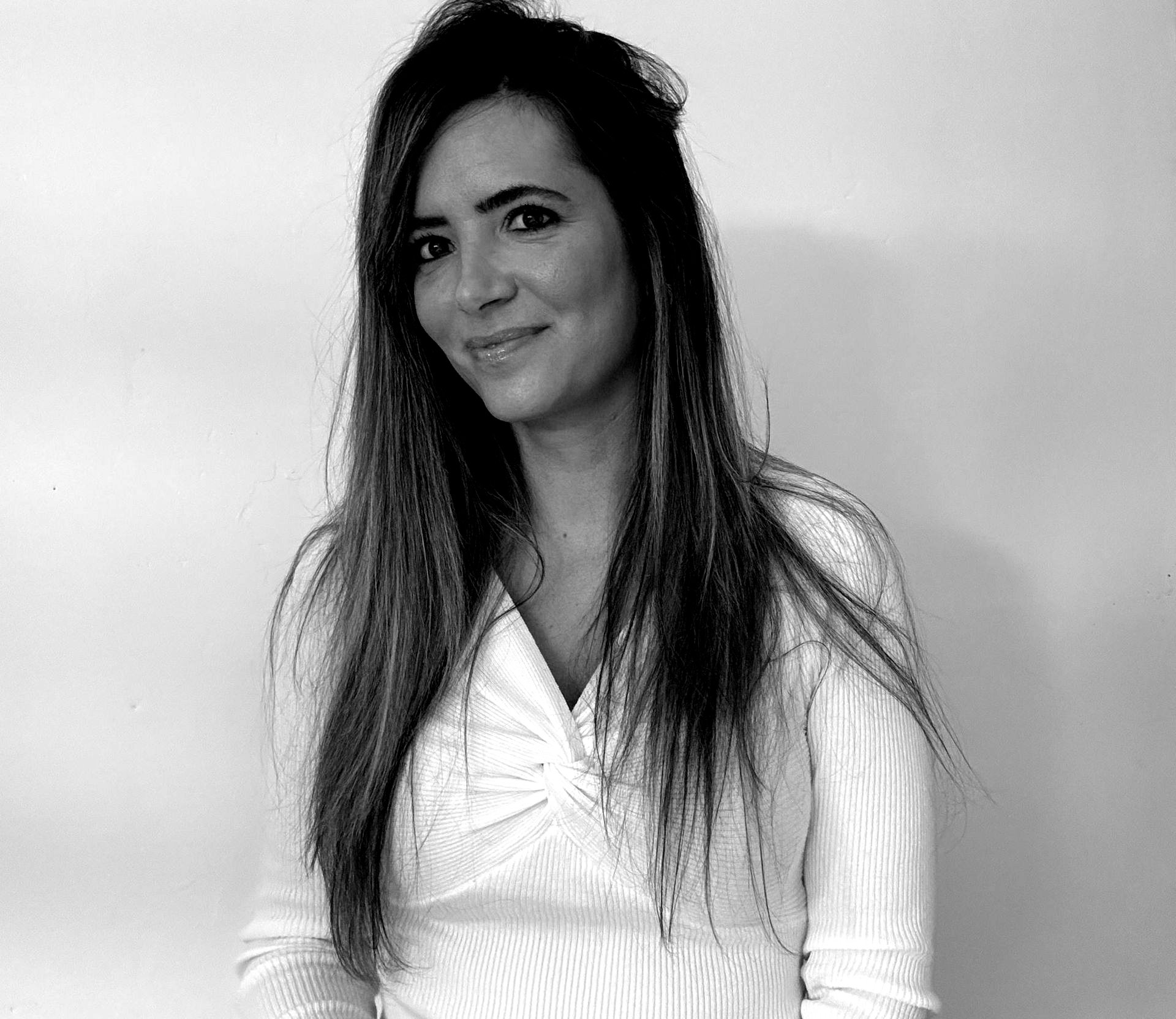 A man is holding a cat in his arms in a black and white photo