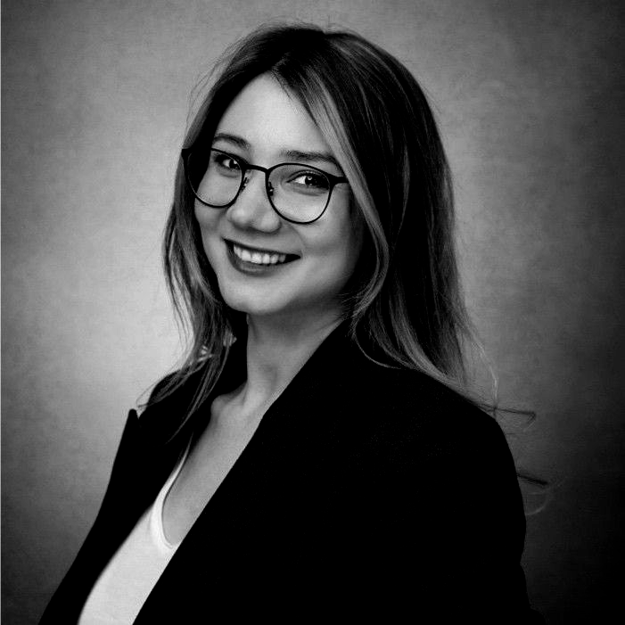 A man is holding a cat in his arms in a black and white photo