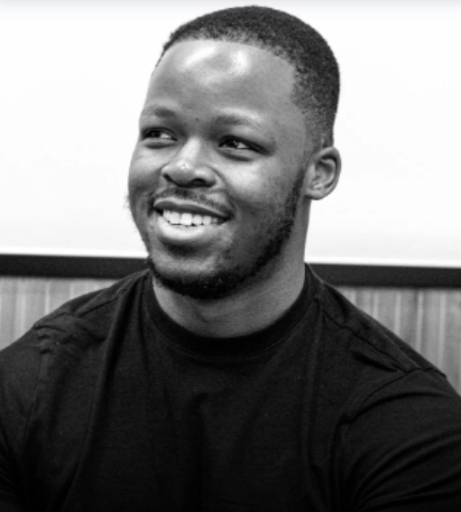 A man is holding a cat in his arms in a black and white photo