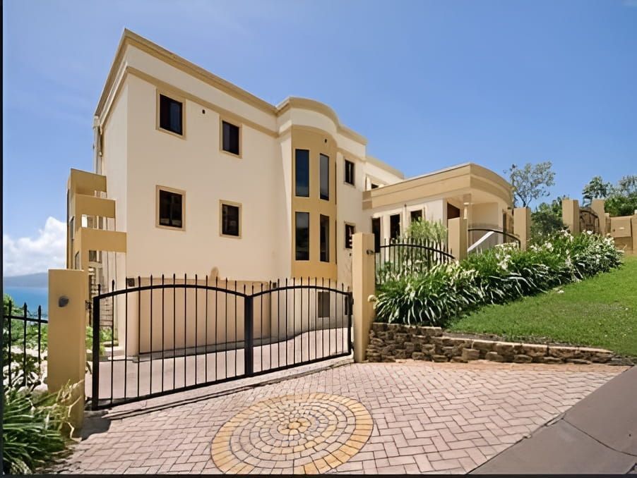 A large house with a gated driveway leading to it — Marteene Painting Services In Kirwan, QLD