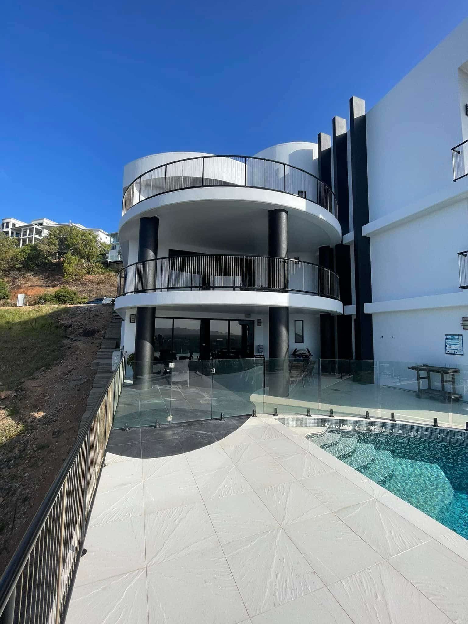 A large white house with a swimming pool in front of it. — Marteene Painting Services In Kirwan, QLD