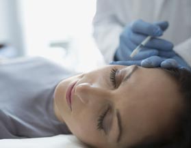 A woman receiving a cosmetic injection in Midland, MI