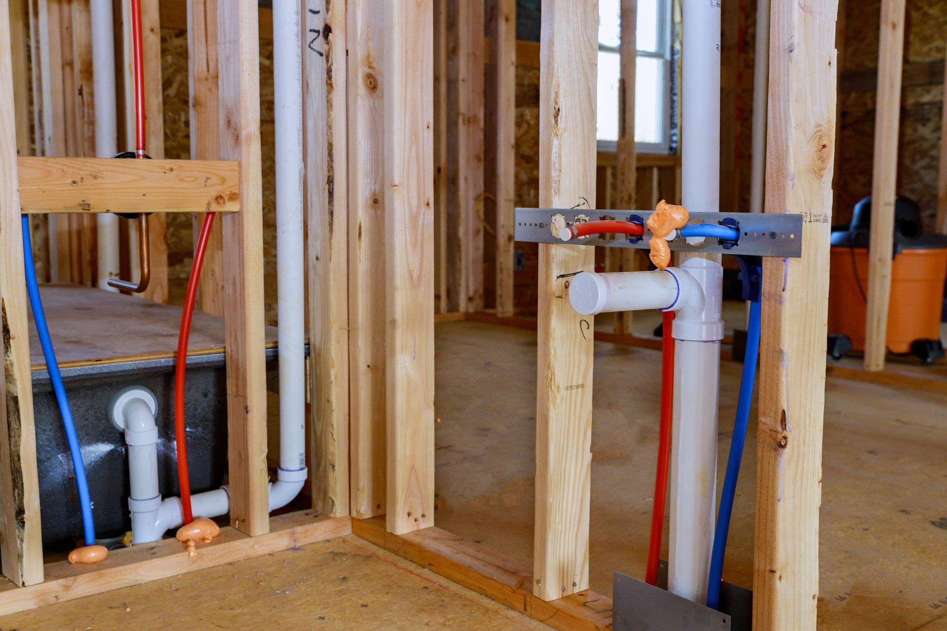 Plumber sets up electric heating boiler at home bathroom.