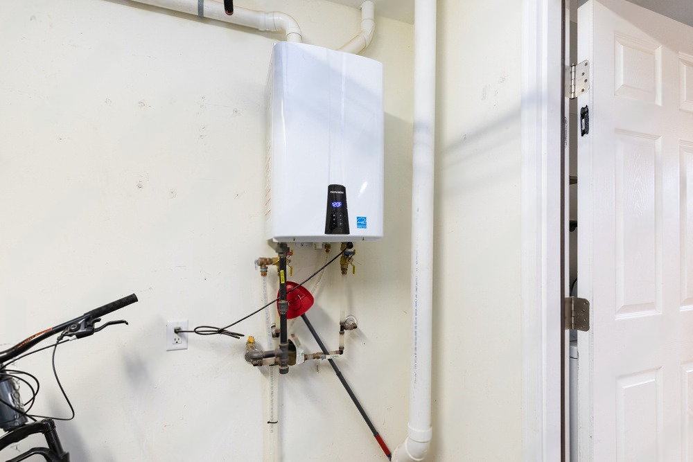 Technician performing maintenance on a heating boiler, inspecting and servicing its components for optimal functionality.