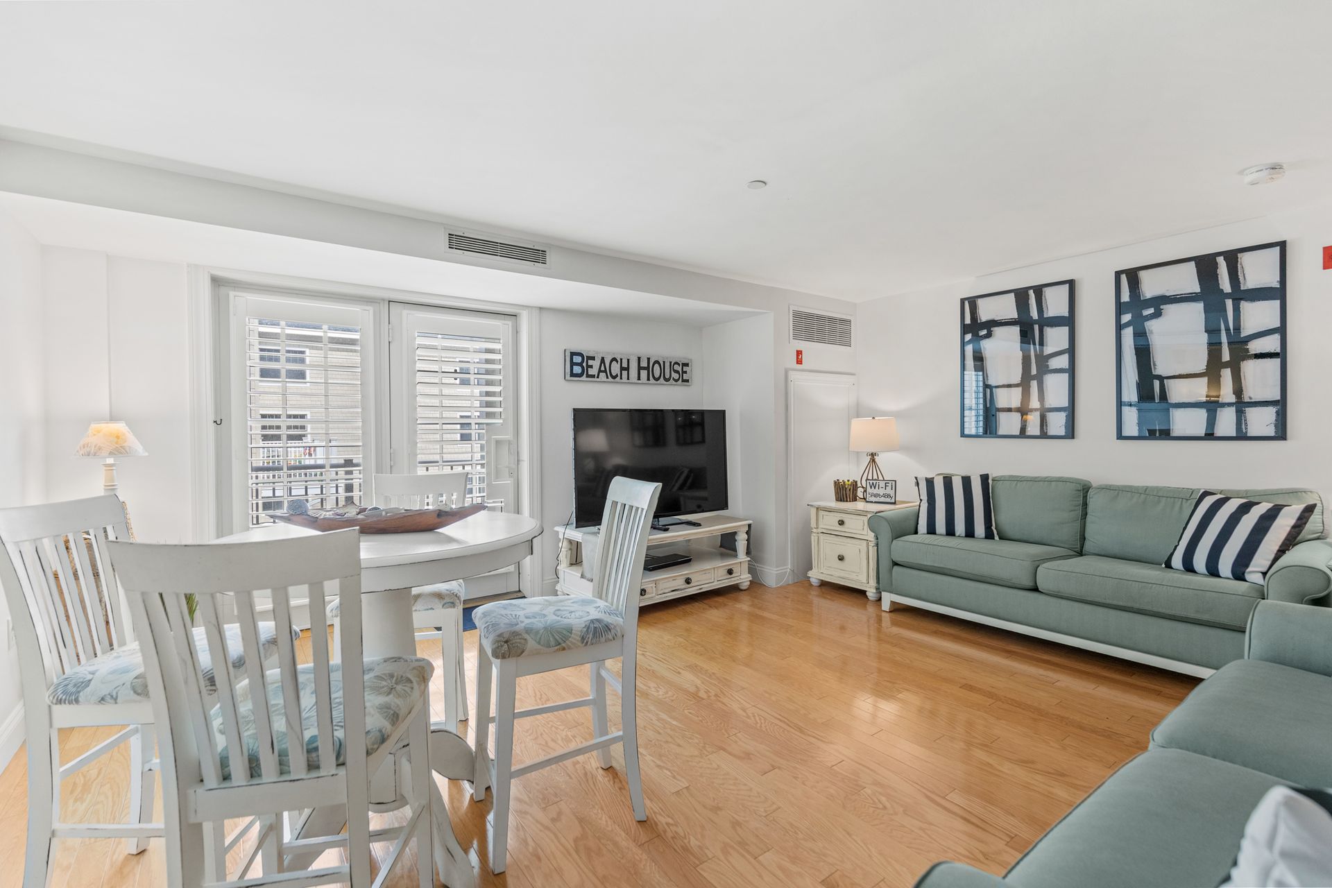 A living room with a couch , table and chairs.