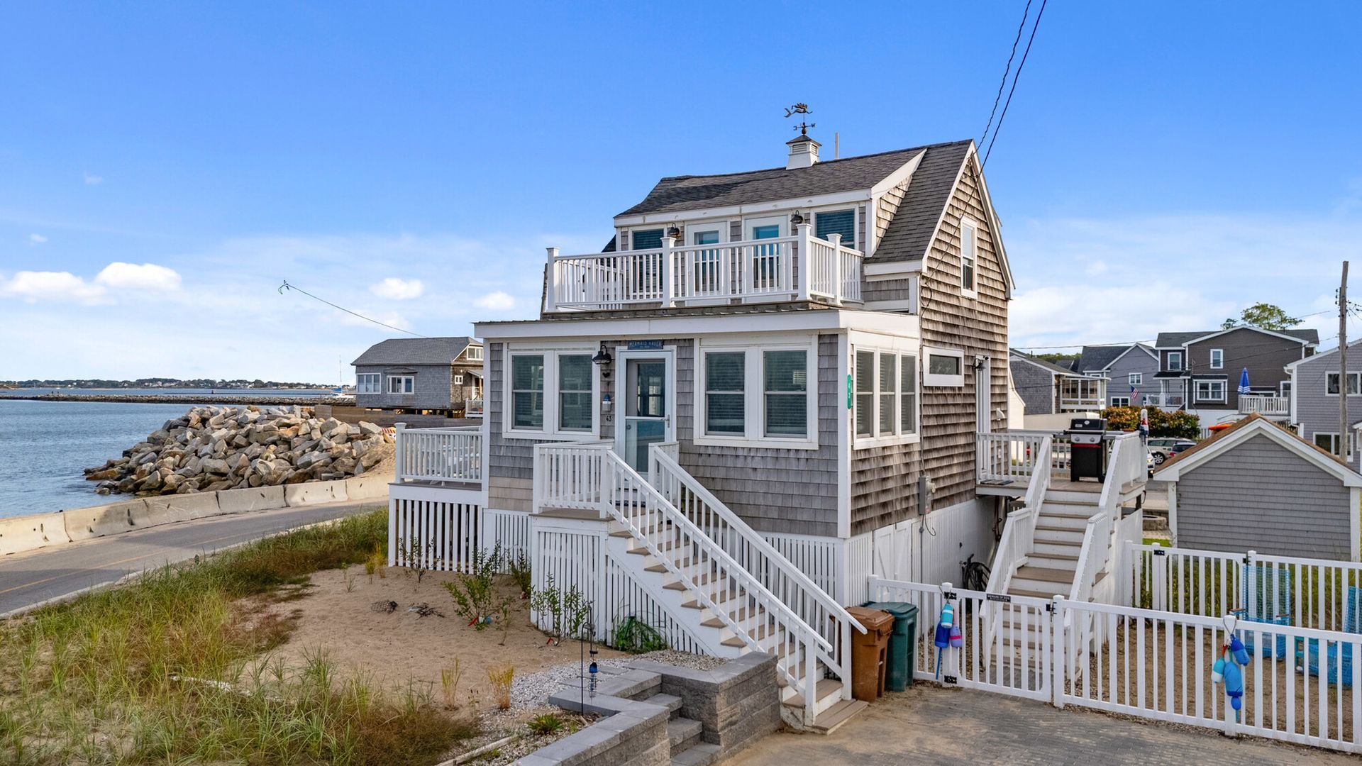 Coastal home with wooden siding and deck; ocean view.