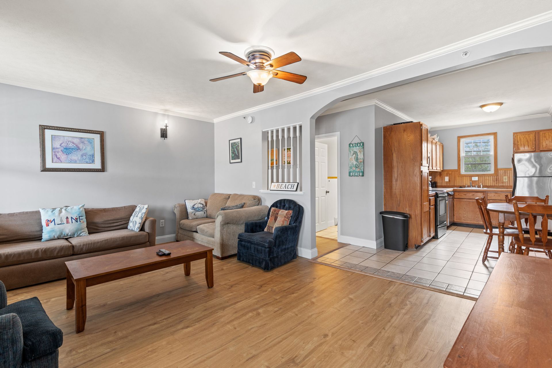 A living room with two couches and two chairs