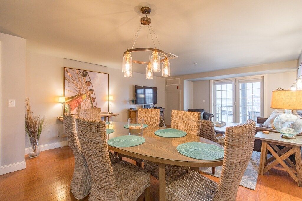A dining room with a table and chairs and a chandelier.