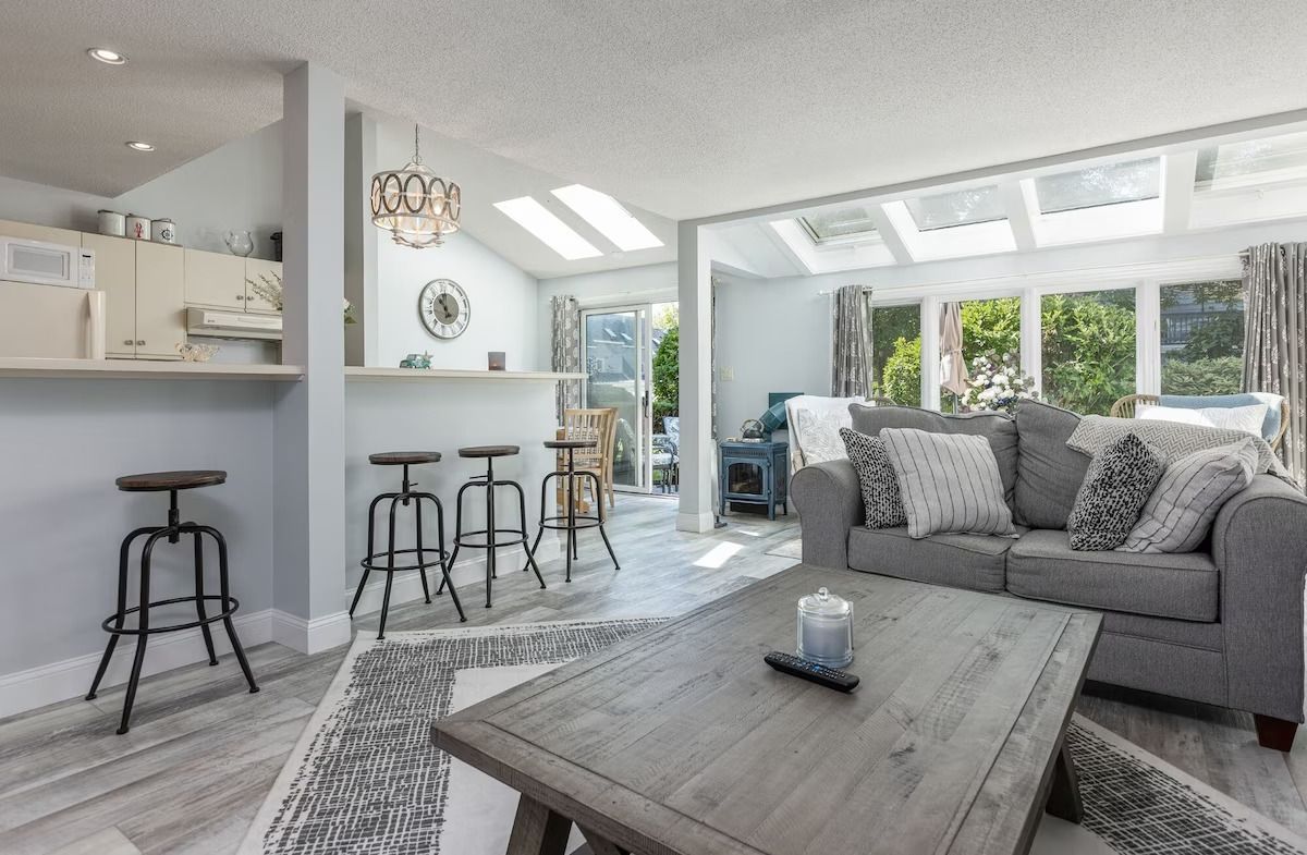 A living room with a couch , coffee table , and stools.
