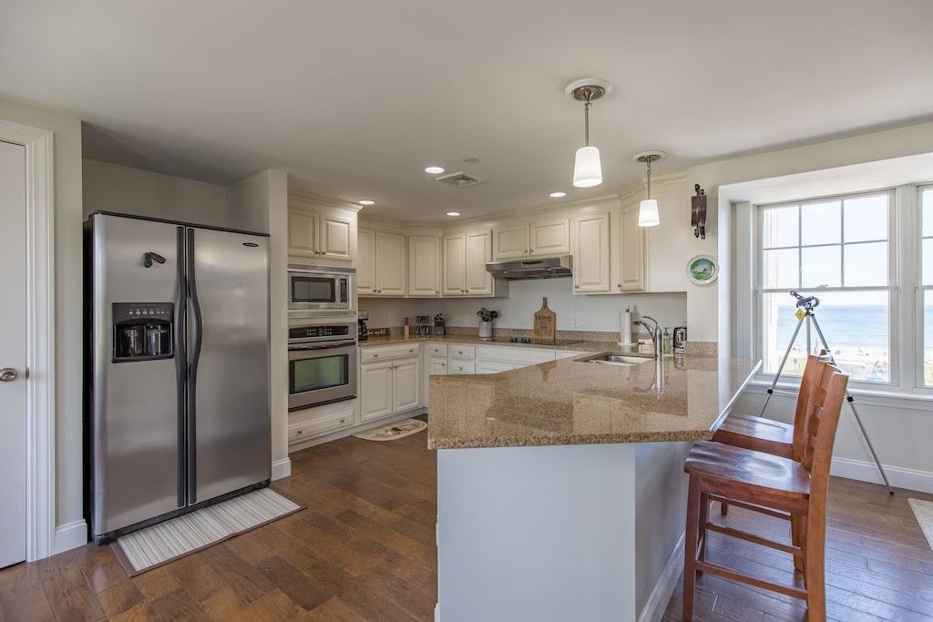 A kitchen with stainless steel appliances and granite counter tops.