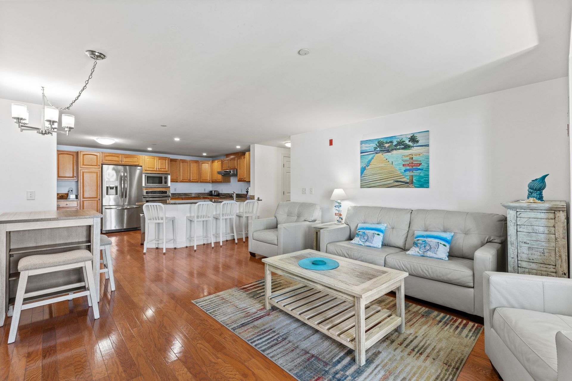 A living room with a couch , chairs , and a table.