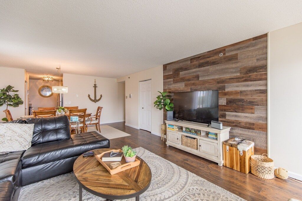 A living room with a couch , table , and television.