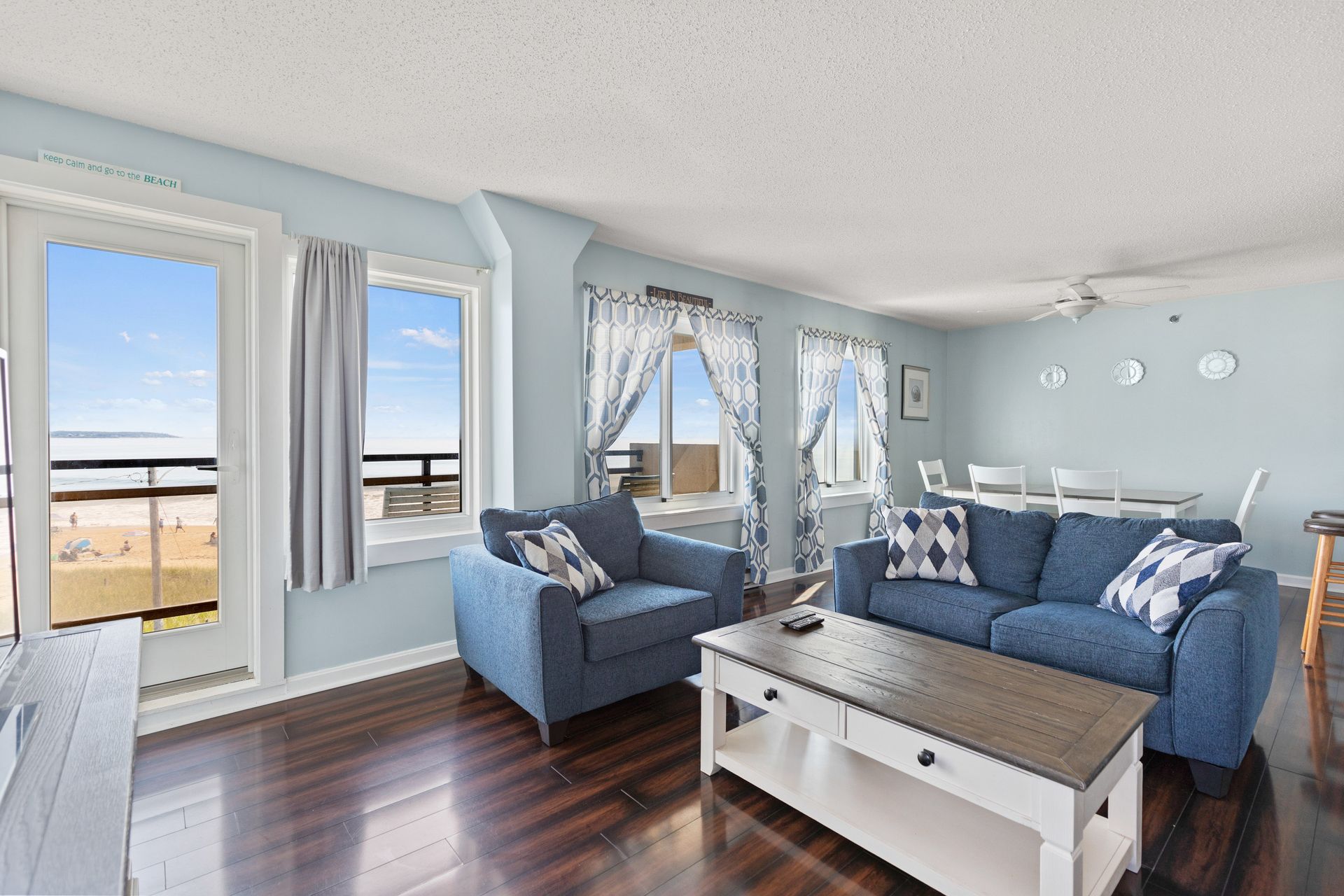 A living room with a blue couch and a white coffee table