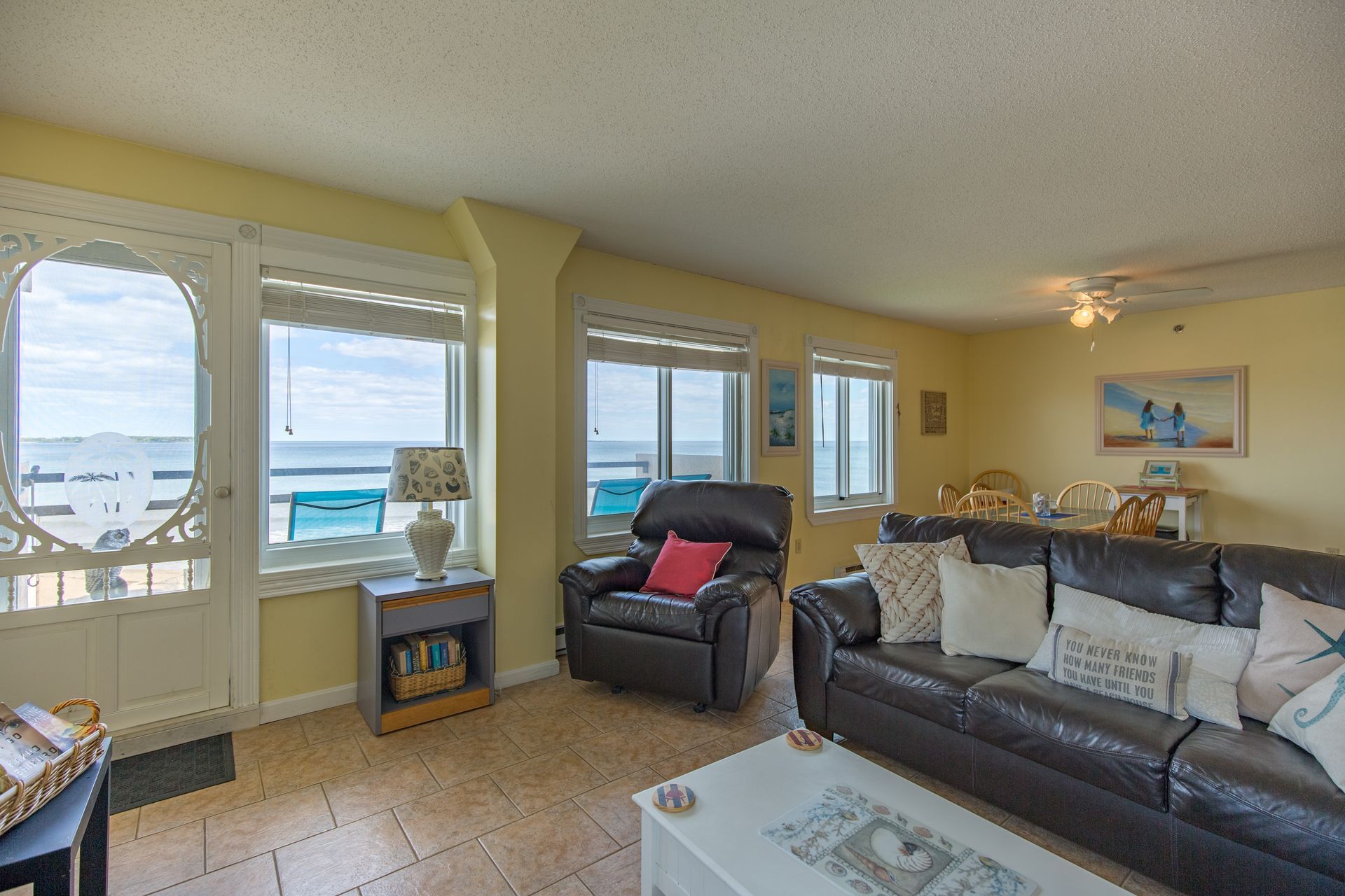 A living room filled with furniture and a view of the ocean.
