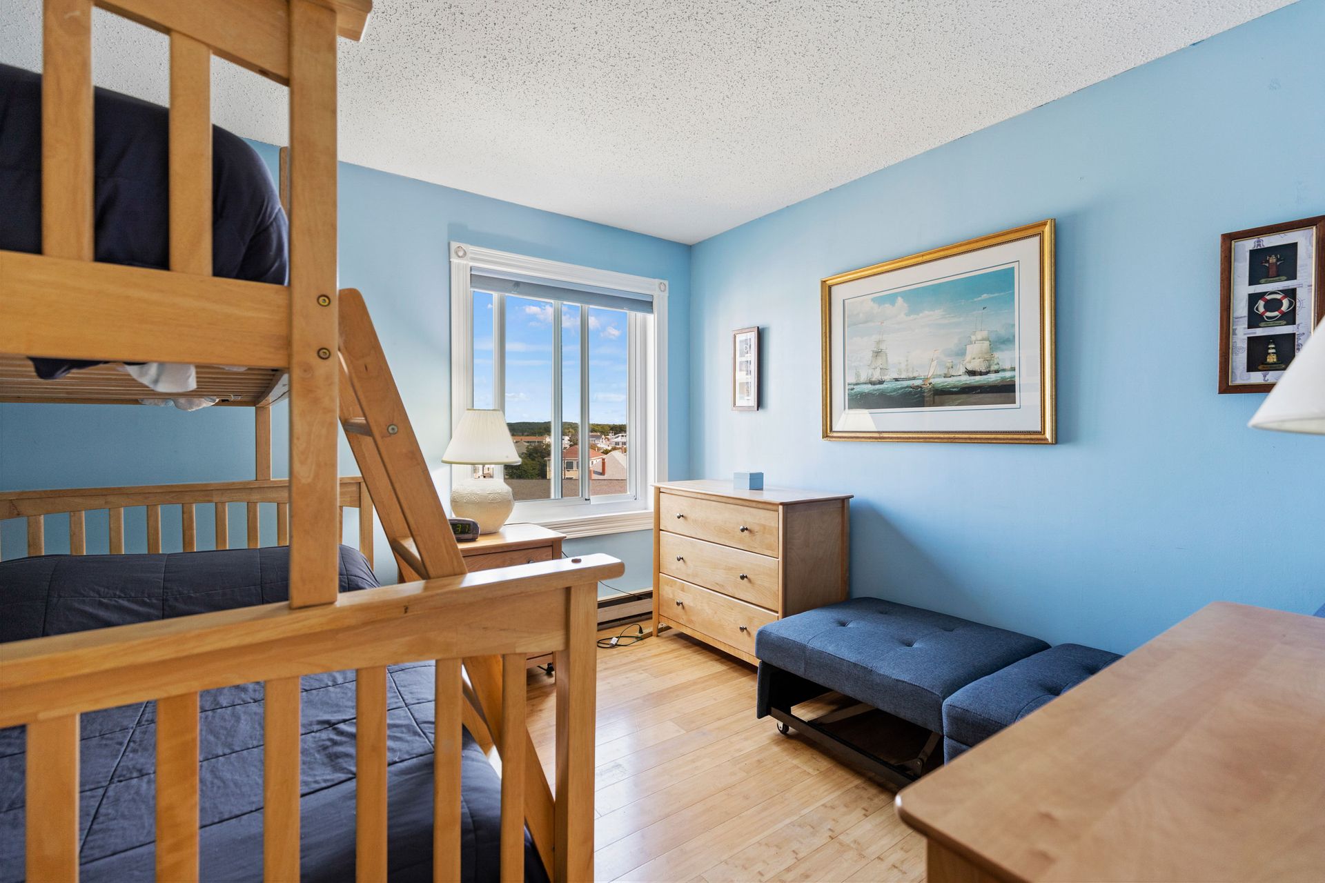 A bedroom with blue walls and a bunk bed