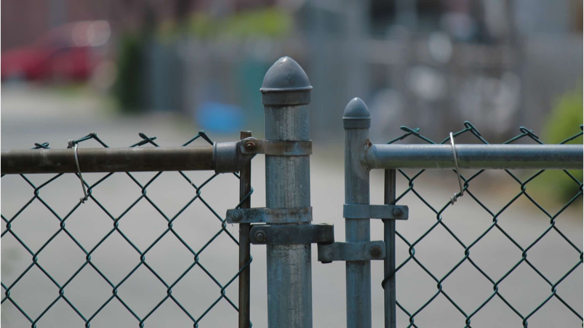 A chain link fence with a gate that is open