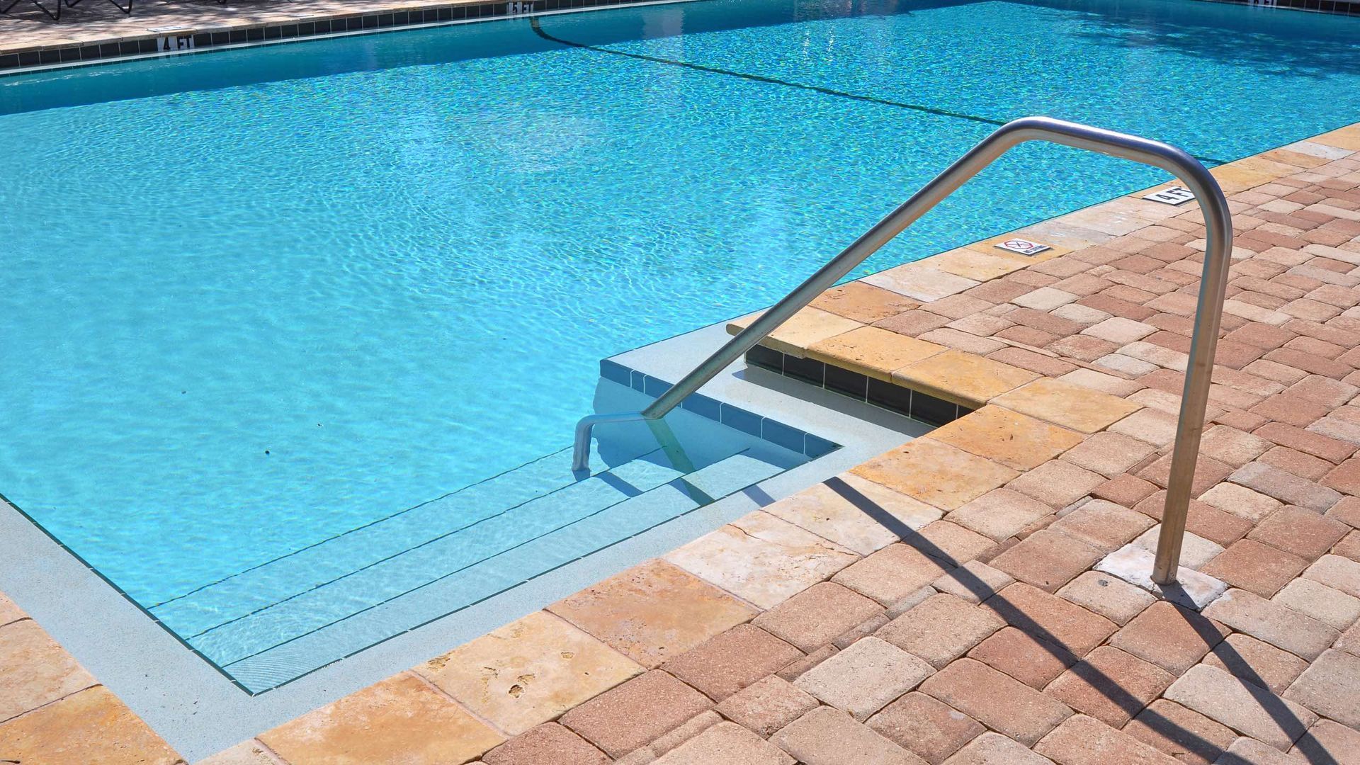 A swimming pool with stairs leading up to it