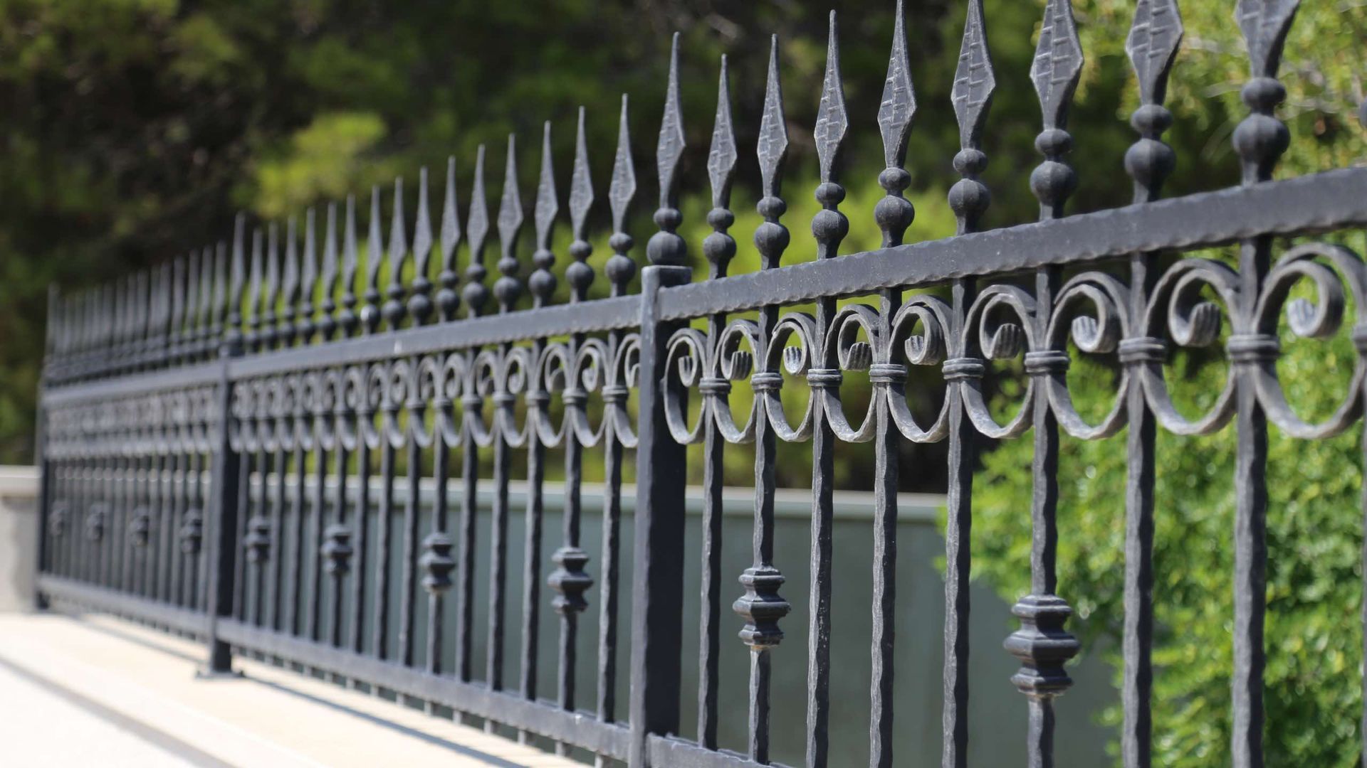A close up of a wrought iron fence on a bridge