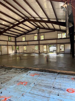 A large building with a concrete floor under construction.