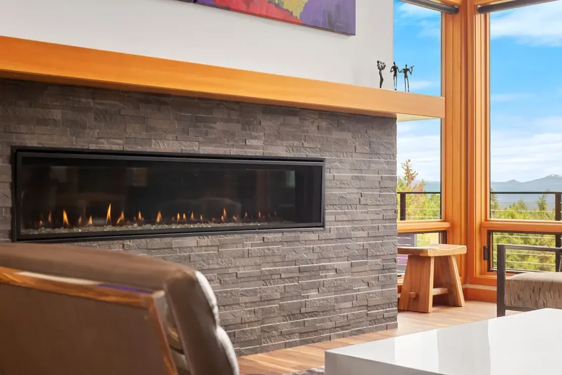Contemporary fireplace with thick wood mantel in bright living room
