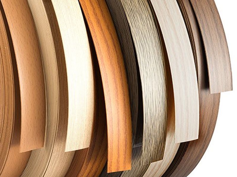 Curved wood veneer samples in natural tones fanned out in a close-up display