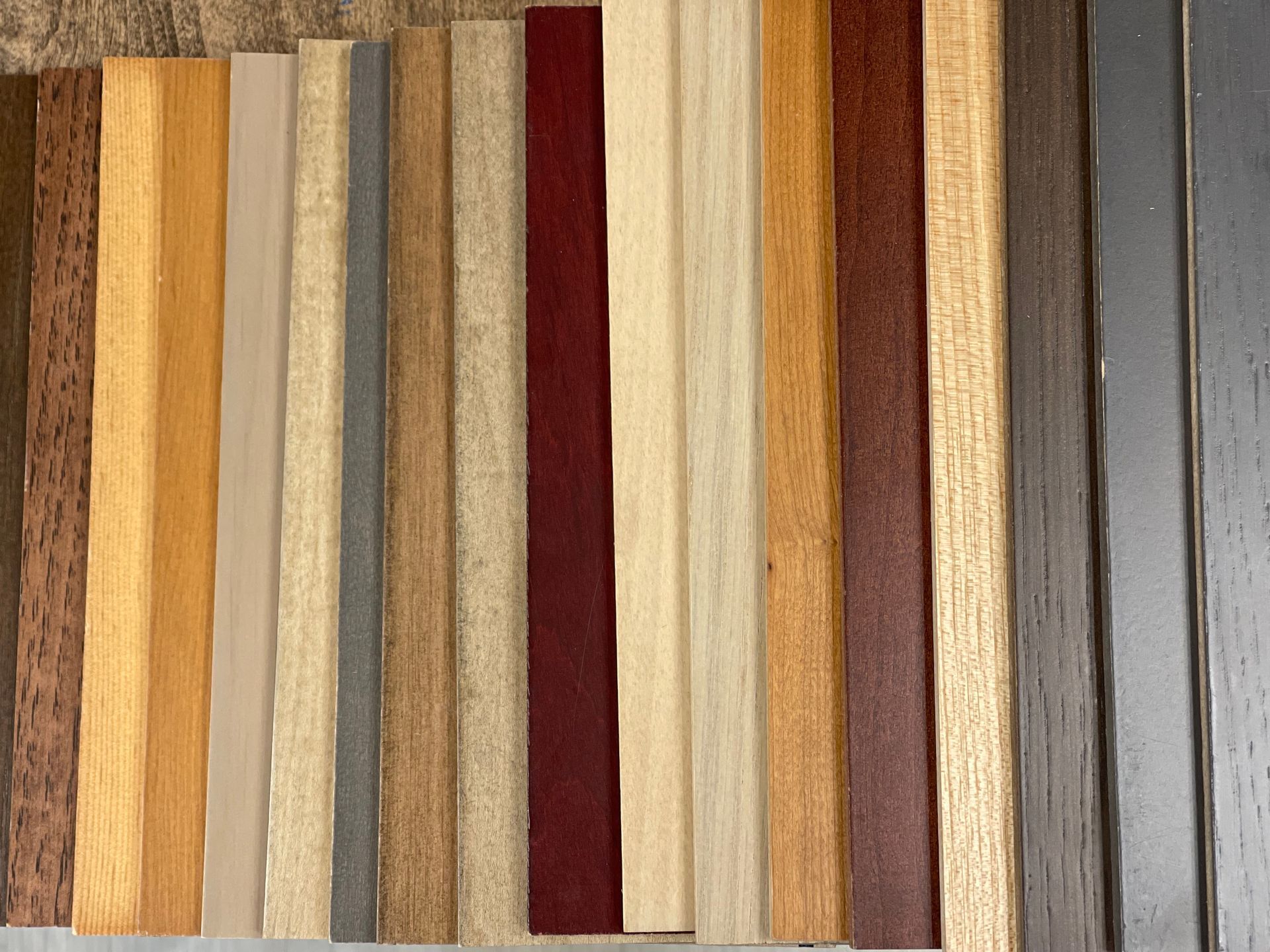 Various strips of wood in different colors and textures, arranged side by side.