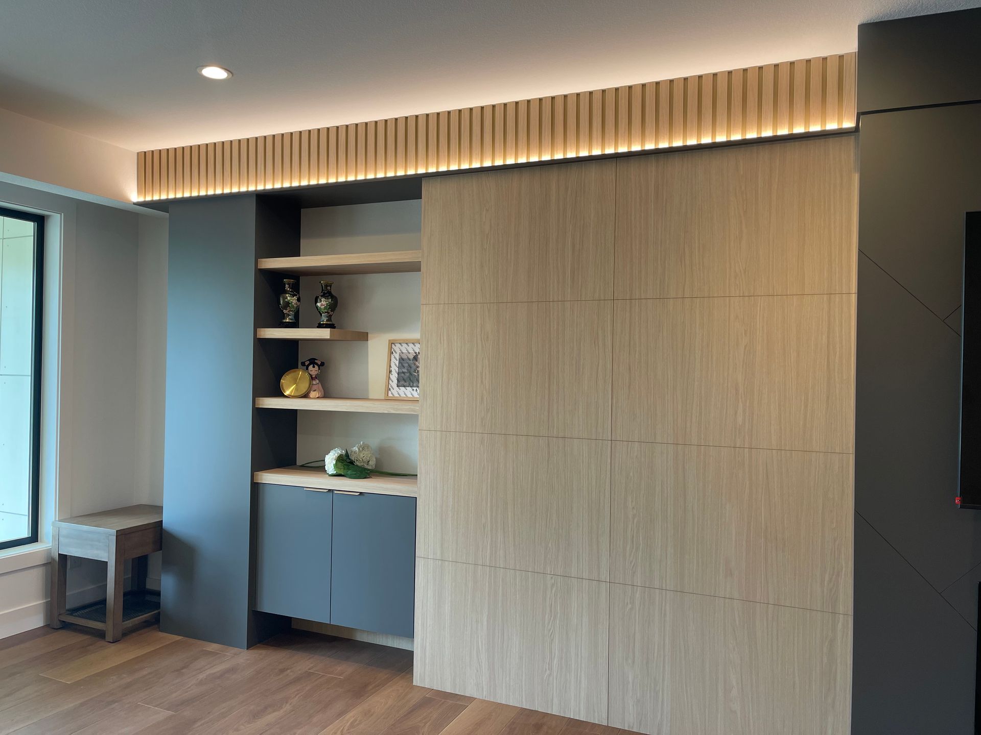 Pro-Tech Woodworking custom handcrafted wood feature wall with built-in shelves and sliding panel, made to order in Portland