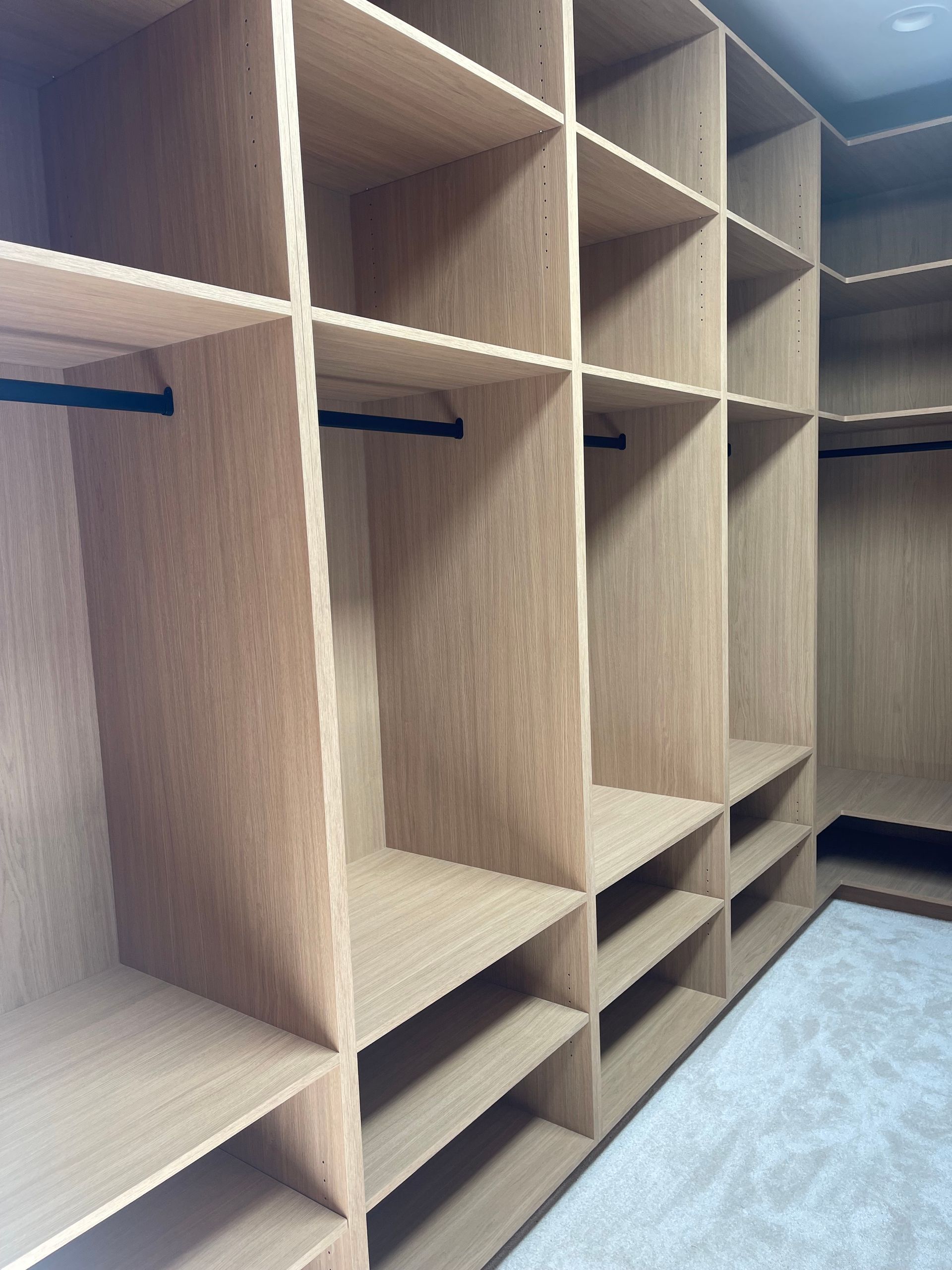 Pro-Tech Woodworking custom closet system with open shelves and hanging rods, made to order in Portland