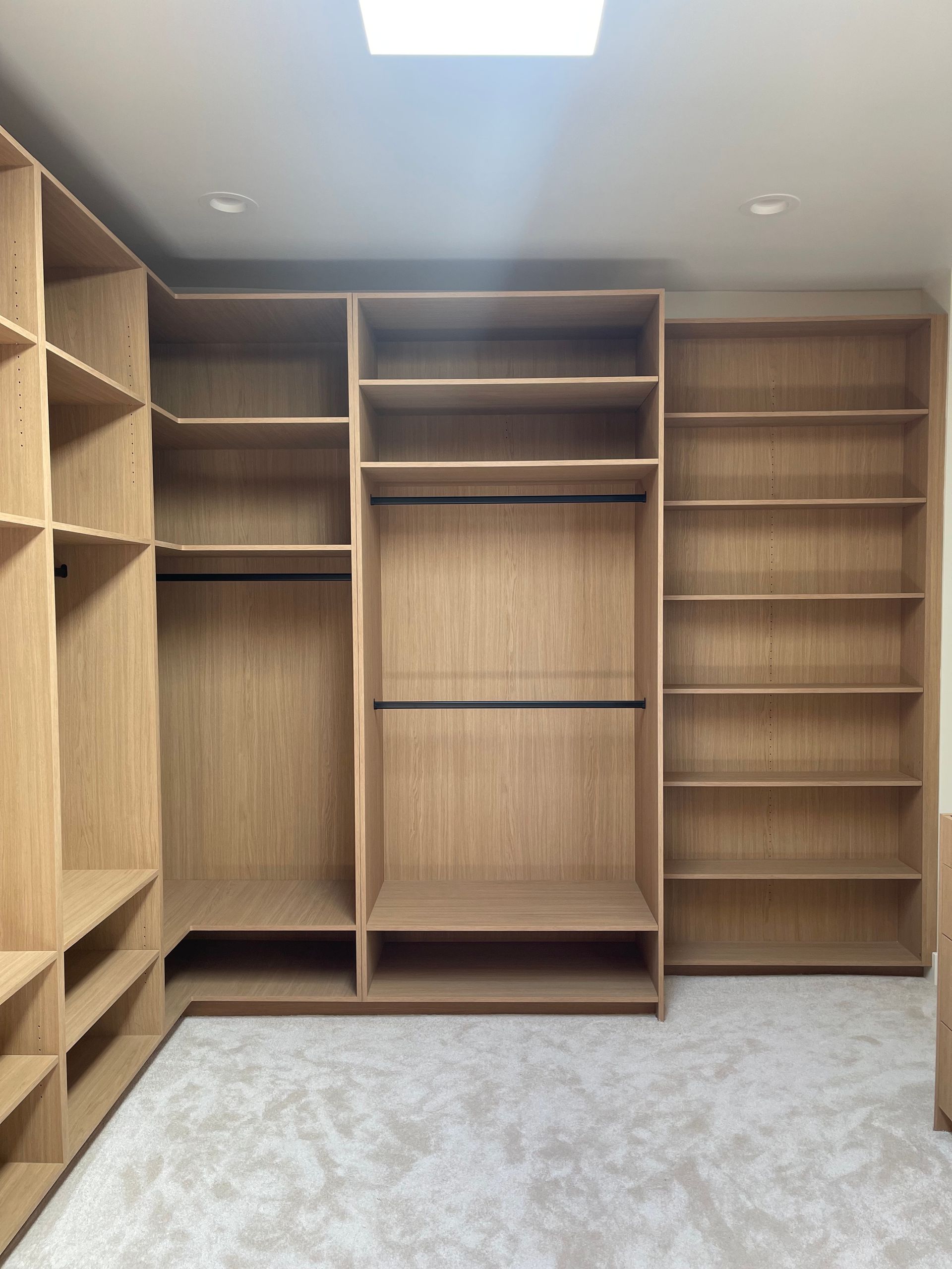 Pro-Tech Woodworking custom closet with multiple open shelves and compartments, made to order in Portland