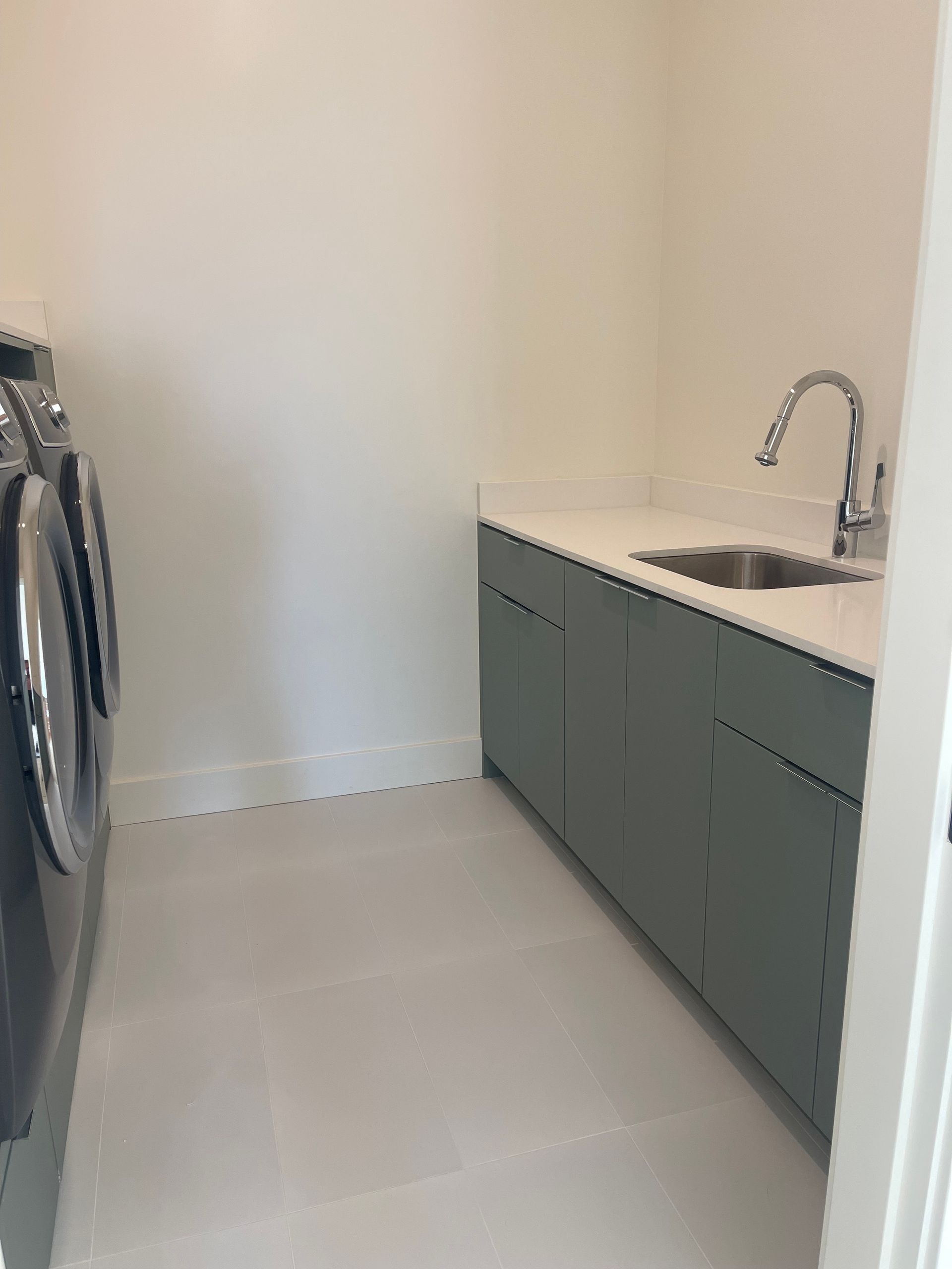 Pro-Tech Woodworking custom laundry room cabinets with built-in sink and base cabinets, made to order in Portland