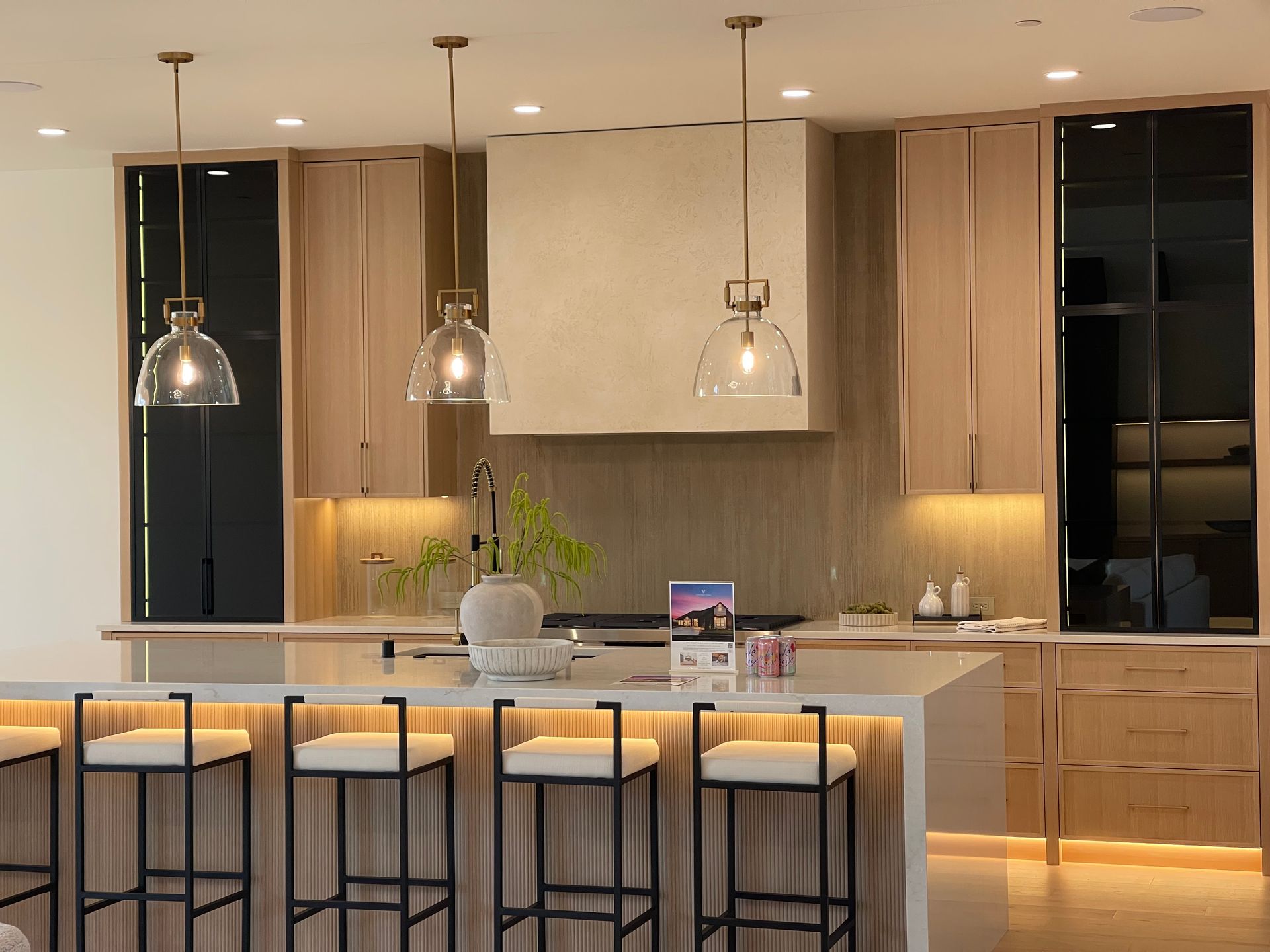 Modern kitchen with island seating, pendant lights, and warm wood cabinetry in Portland, Oregon, WA