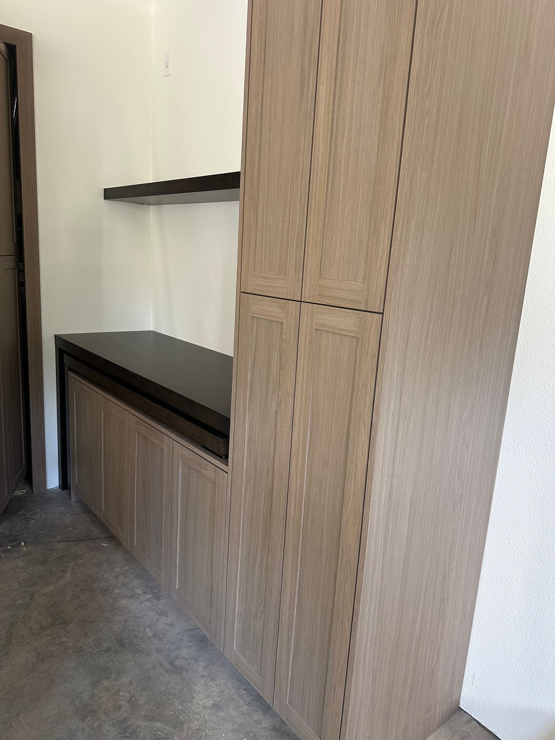 Tall storage cabinet with stained wood finish — laundry/mudroom by Pro-Tech Woodworking, Portland
