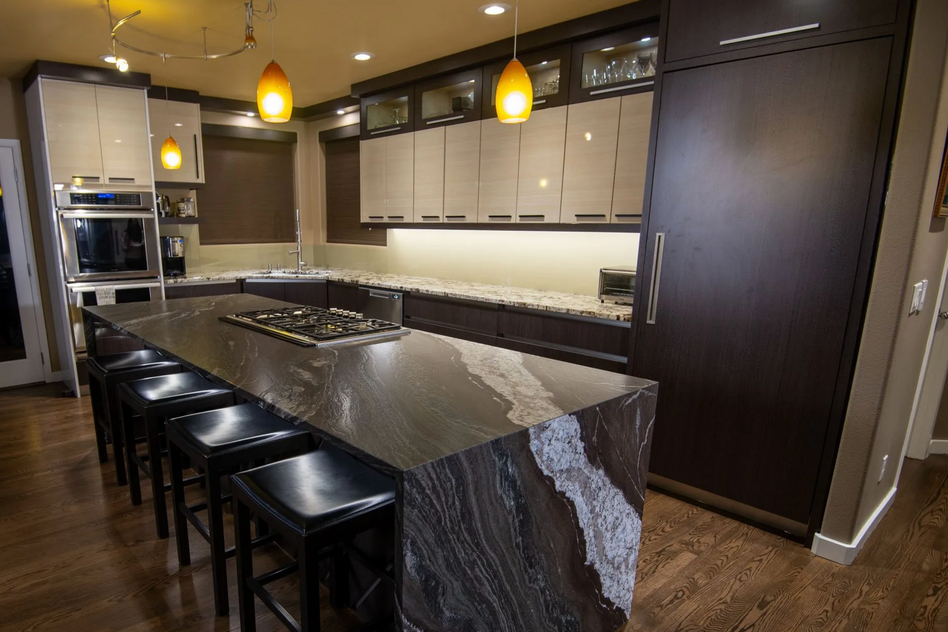 Large custom kitchen in Portland with island, pendant lighting, and dark wood cabinetry