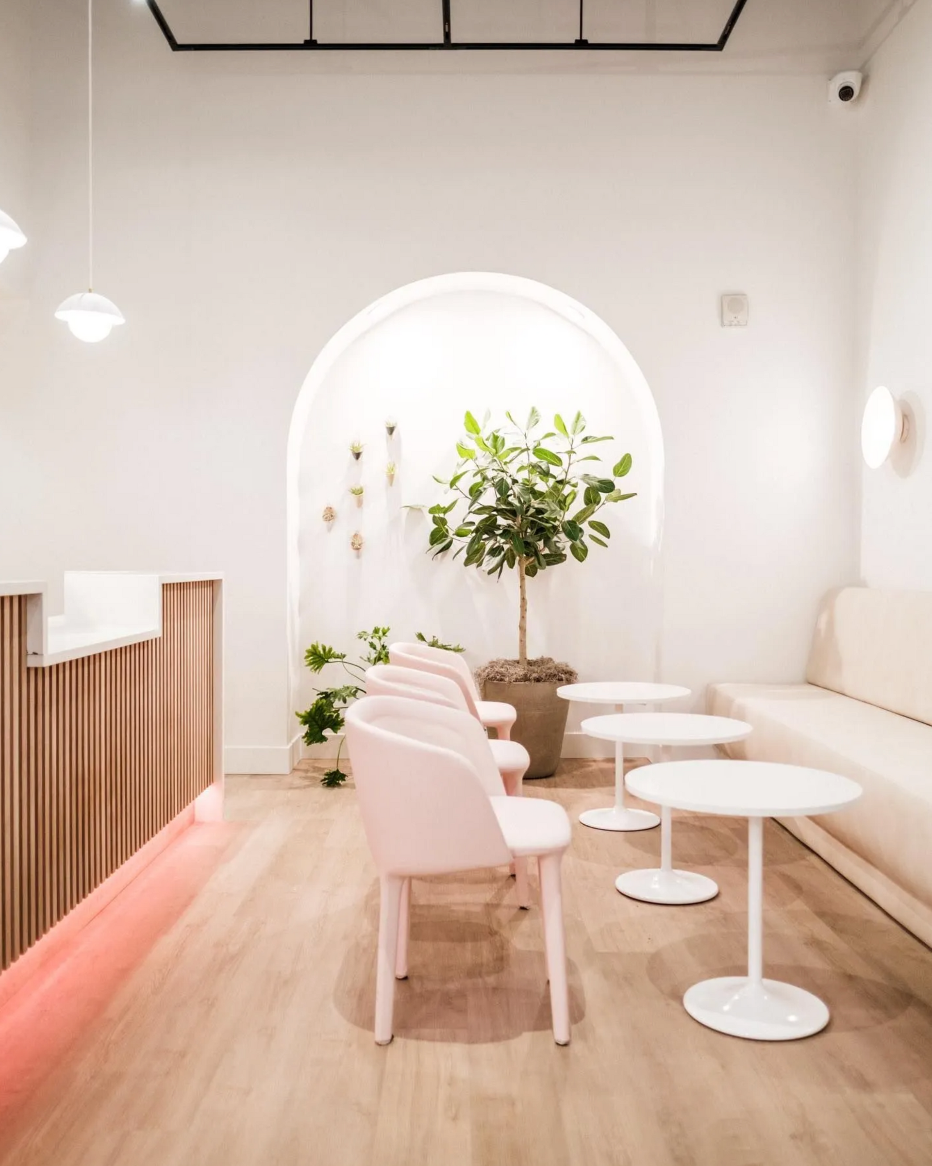 Reception or spa room with arched wall, custom cabinet and floral decor