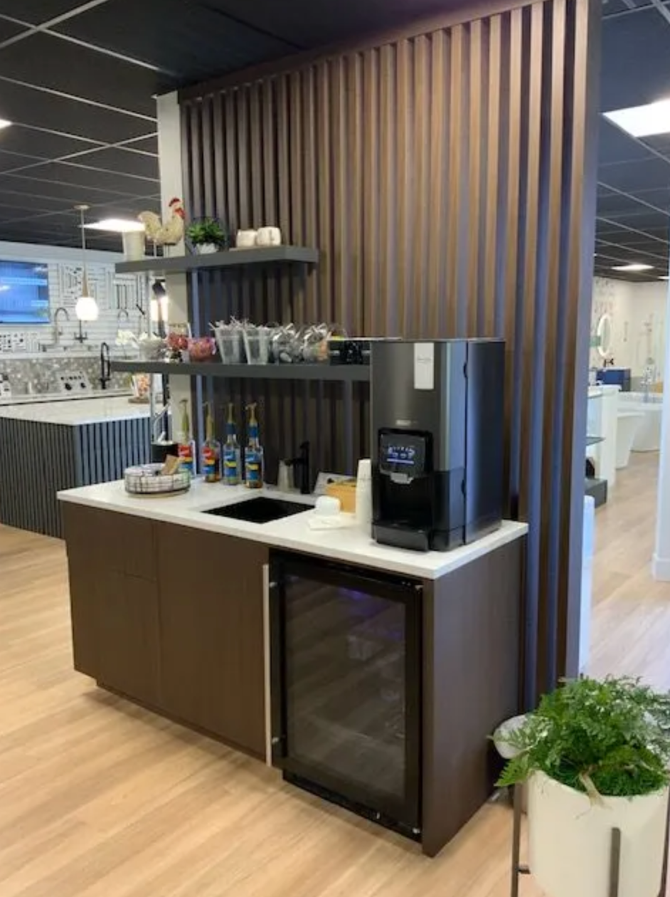 Coffee station with built-in cabinet and open shelves in commercial kitchen or office
