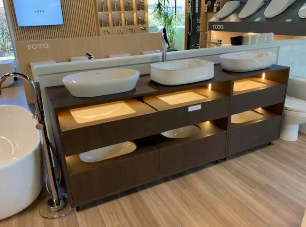 Commercial vanity with vessel sinks and open wood cabinetry below