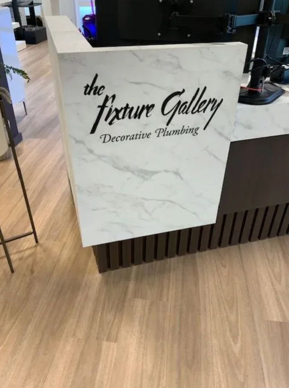 Reception cabinet with marble display and vertical slat front — Pro-Tech commercial cabinetry