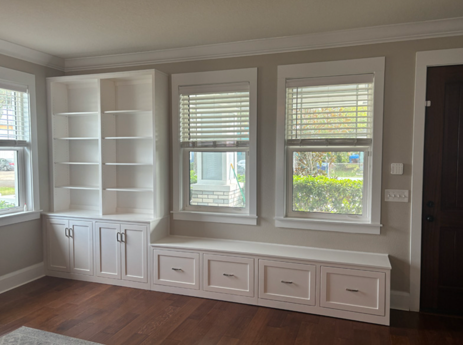 Large window with custom sill and white molding overlooking the yard in Portland by Pro-Tech Woodworking