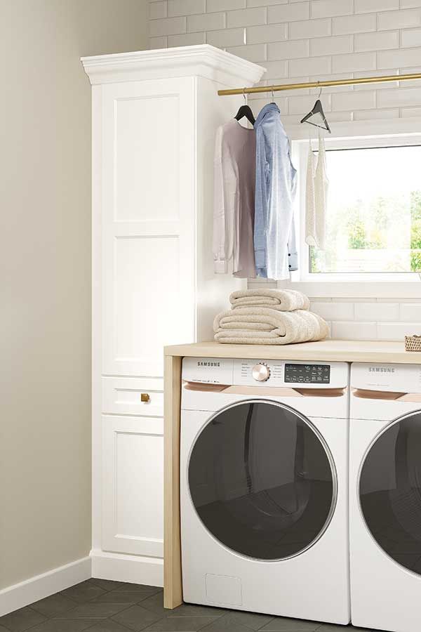 Laundry room with custom cabinets and washer/dryer — Portland project by Pro-Tech Woodworking