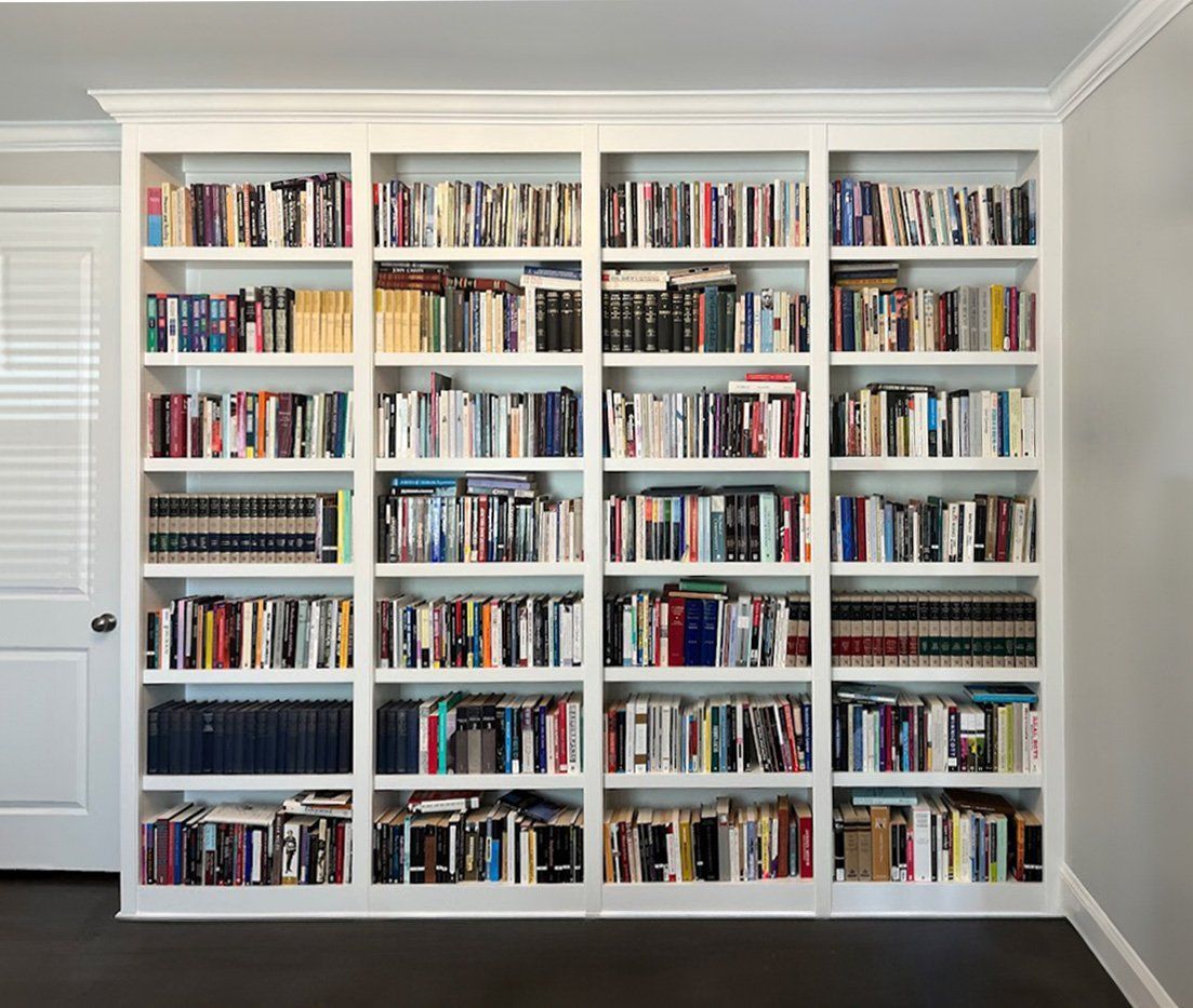 White bookcase with full-height shelving — Portland home library by Pro-Tech Woodworking