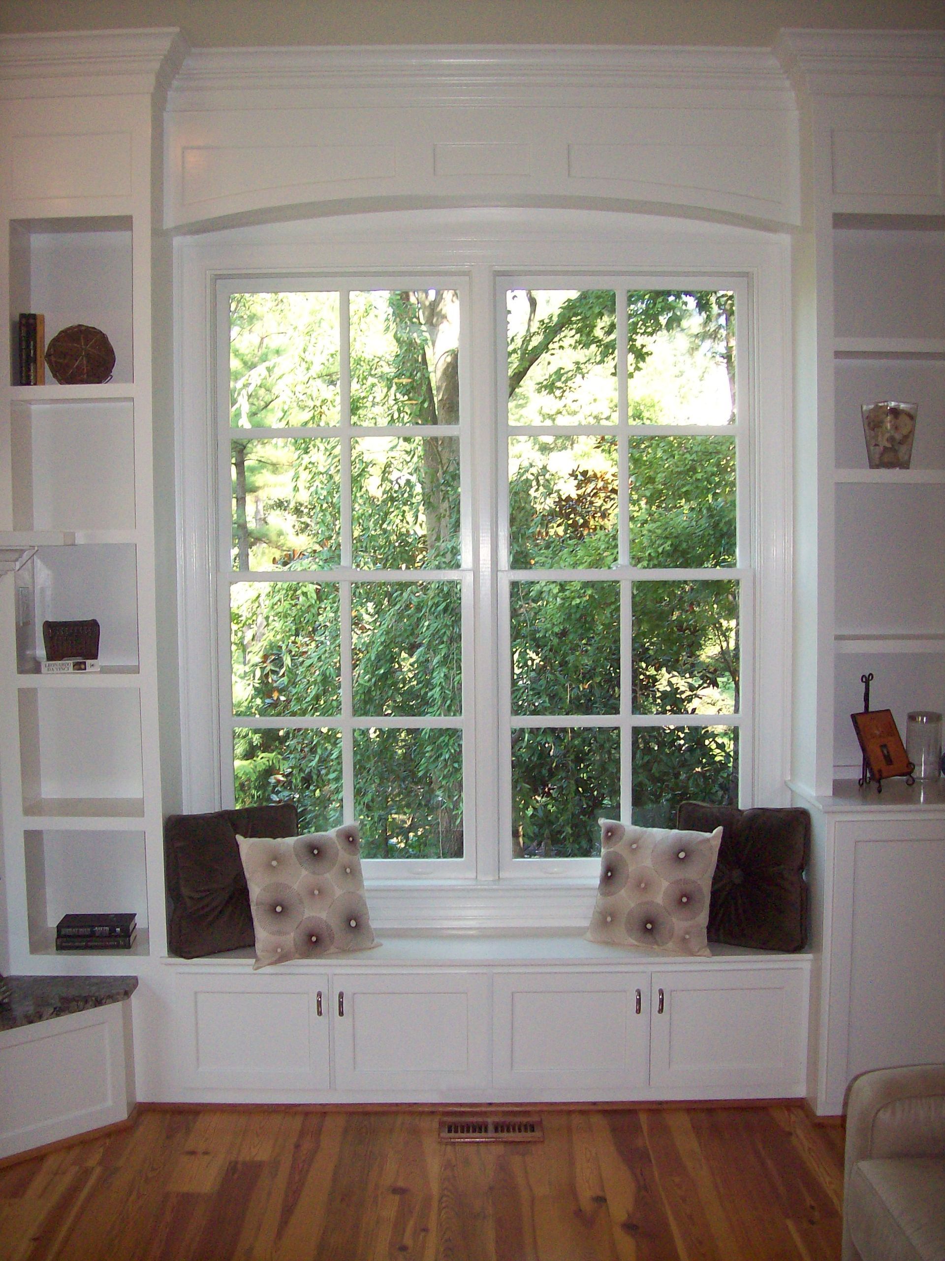Built-in window seat with shelving on both sides and garden view