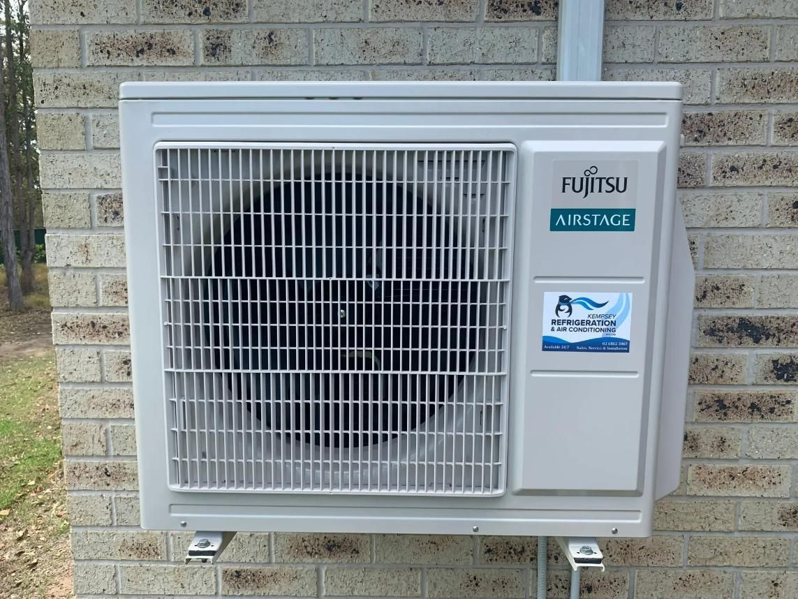 Fujitsu Air Conditioner On A Brick Wall — Air Conditioner in Macksville, NSW