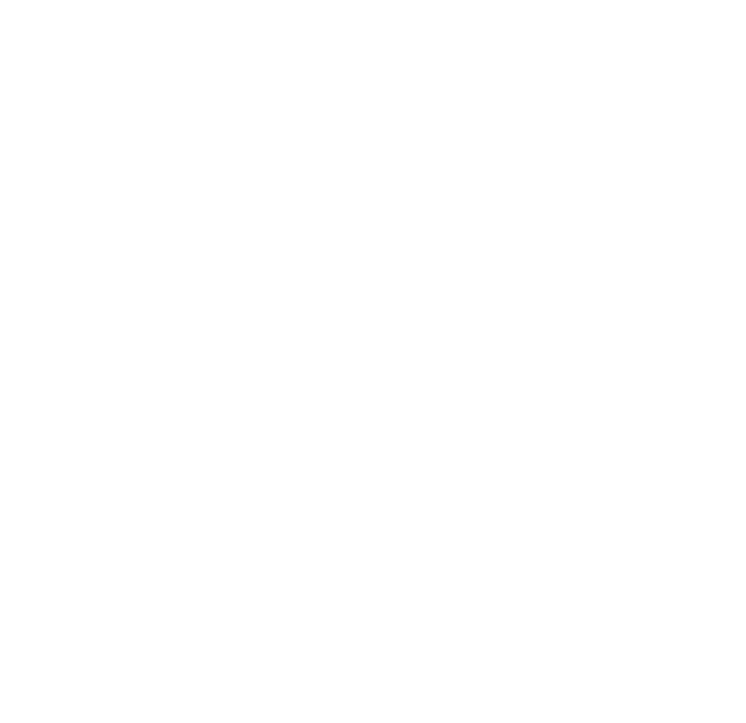 A man with a beard is wearing a blue sweater and smiling.